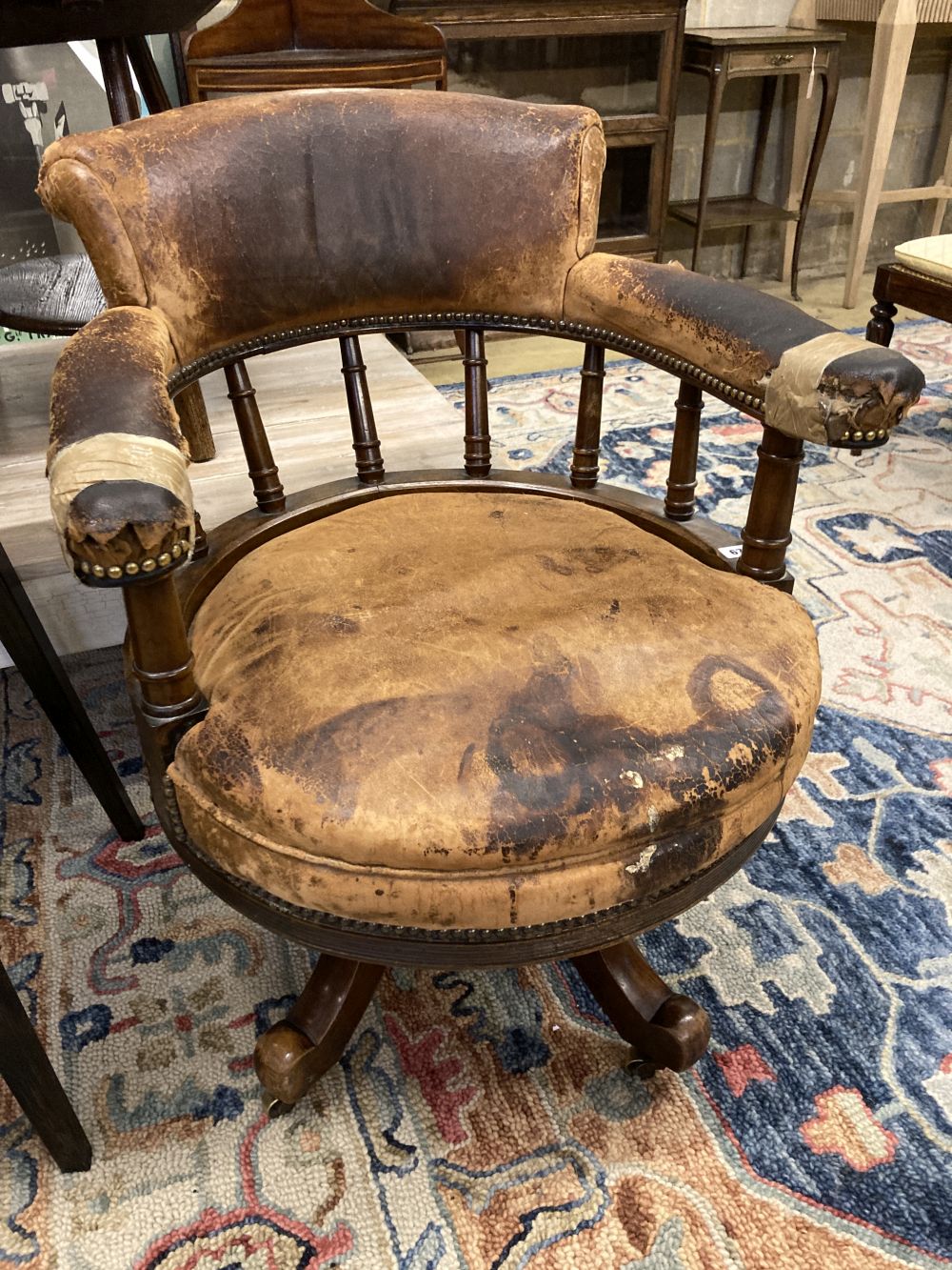 A Victorian leather upholstered mahogany swivel desk chair